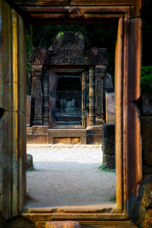 A sequence of ancient doorways aligned within one another, creating a layered view deep into the interior of an Angkor temple.