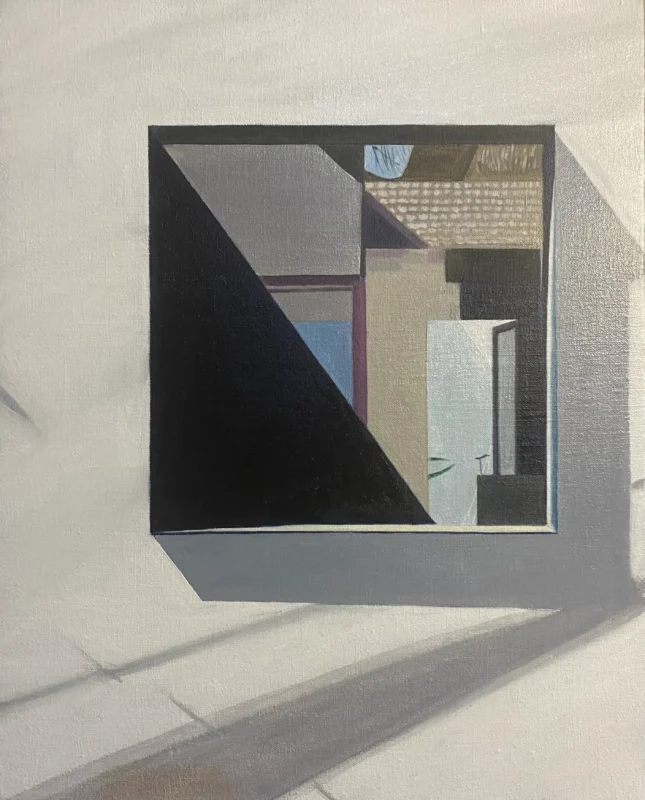 A square window opening frames fragments of architecture and strong afternoon shadows, transforming an ordinary courtyard view into a geometric composition.