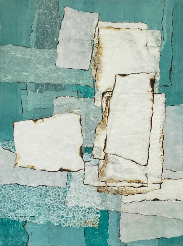 Minimal paper assemblage composed of layered handmade paper on a turquoise surface.