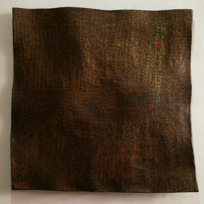 Layered traces of writing emerge beneath accumulated surfaces, creating an abstract composition reminiscent of aged manuscripts and the passage of time.