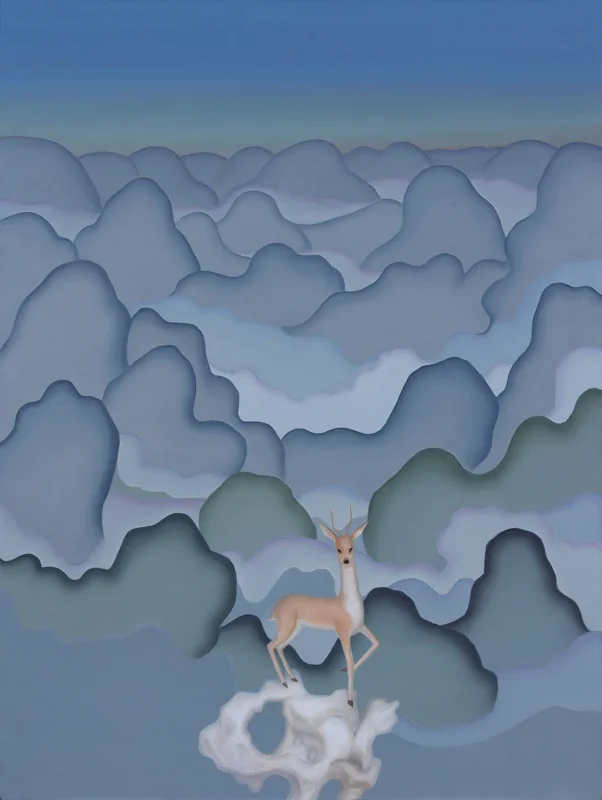 A deer stands atop a pale rock overlooking endless layers of rolling mountains that stretch into the distance beneath a luminous sky.