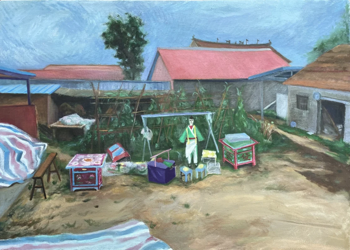 Paper funeral offerings arranged in a rural courtyard before a funeral ceremony